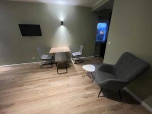 a room with a table and chairs and a tv at Milano Apartment in Hamburg
