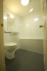 a bathroom with a toilet and a sink at Ayre Hotel & Ayre Apartments in Kirkwall