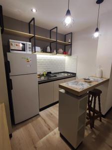 a kitchen with a white refrigerator and a counter at Departamento - Salta Capital ae - Edificio Usina in Salta