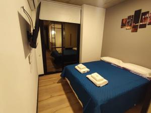 a room with a blue bed with two towels on it at Departamento - Salta Capital ae - Edificio Usina in Salta