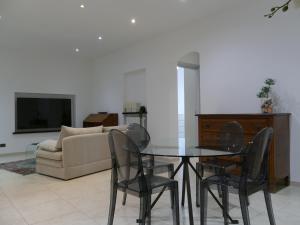 a living room with a table and chairs and a couch at Andrea Appartamenti in Savona