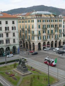 a city with a statue in front of a building at Andrea Appartamenti in Savona