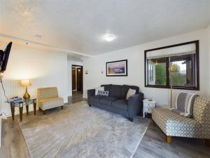 a living room with a couch and two chairs at Oceanfront Apartment with Sauna and Covered Deck in Juneau +21 photos