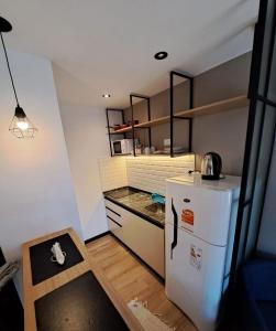 a small kitchen with a refrigerator and a counter at Departamento - Salta Capital ae - Edificio Usina in Salta