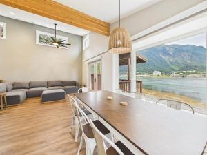 a dining room with a large wooden table and chairs at Oceanfront w Incredible Views in Juneau