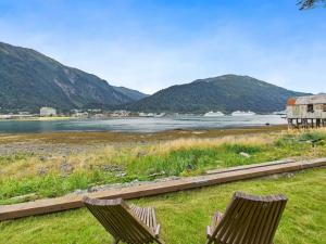 two chairs sitting on the grass near a body of water at Oceanfront w Incredible Views in Juneau