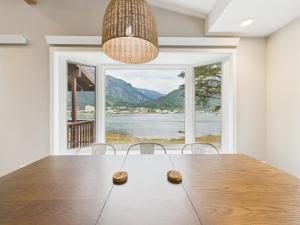 a dining room with a table and a large window at Oceanfront w Incredible Views in Juneau