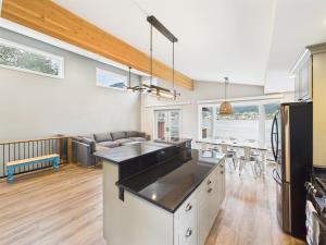 a kitchen and living room with a counter and a table at Oceanfront w Incredible Views in Juneau