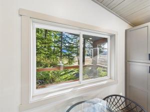 a window in a white room with a table and chairs at Sunny Point 2BR with Deck & Mountain Views in Juneau