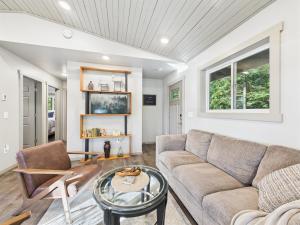 a living room with a couch and a table at Sunny Point 2BR with Deck & Mountain Views in Juneau