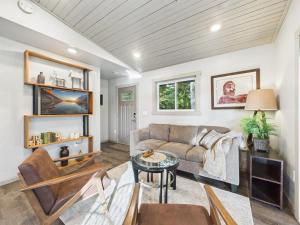 a living room with a couch and a table at Sunny Point 2BR with Deck & Mountain Views in Juneau