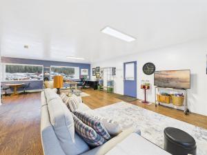 a living room with a couch and a table at Large Juneau Loft w Full Kitchen, WD & Workspace in Juneau