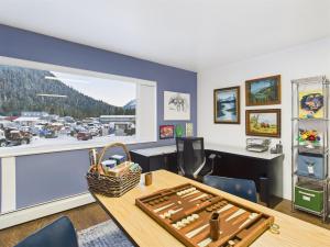 an office with a table and a view of a marina at Large Juneau Loft w Full Kitchen, WD & Workspace in Juneau