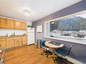 a kitchen with a table and chairs and a window at Large Juneau Loft w Full Kitchen, WD & Workspace in Juneau +9 photos