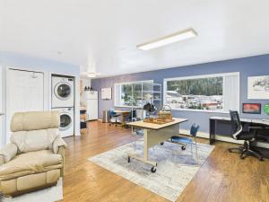 a living room with a desk and chairs at Large Juneau Loft w Full Kitchen, WD & Workspace in Juneau