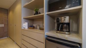 a kitchen with a microwave and a coffee maker at Luxury Oceanfront Condo with Stunning Views in Puerto Peñasco