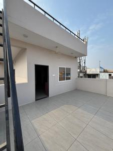 a balcony of a white building with a door at Platform 9 3by4 in Ujjain +9 photos