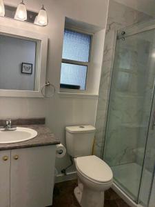 a bathroom with a toilet and a sink and a shower at Memory Lane Guest Suite in Sooke +10 photos