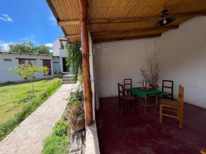 a patio with a green table and chairs at Balcones del Pintor in Maimará