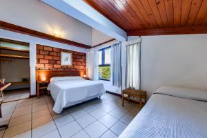 a bedroom with two beds and a television in it at Mirando al Sur in San Carlos de Bariloche