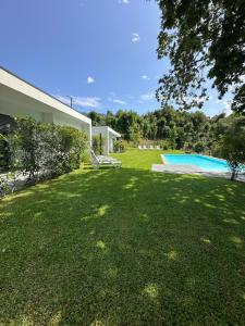 a yard of a house with a swimming pool at Ri&Vale Alojamentos in Vieira do Minho