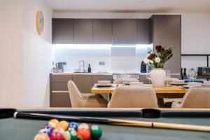 a dining room with a table with a pool table at Leeds Lux Apartment - 2 Bed & Pool Table, Secure Parking in Leeds