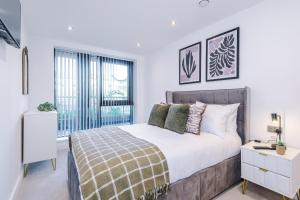a bedroom with a large bed and a window at Leeds Lux Apartment - 2 Bed & Pool Table, Secure Parking in Leeds
