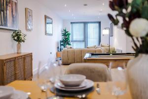 a living room with a table with glasses on it at Leeds Lux Apartment - 2 Bed & Pool Table, Secure Parking in Leeds +43 photos