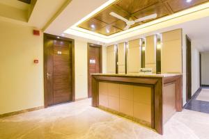 a large room with a vanity and wooden doors at Super OYO 77736 Hotel Starlight in Kānpur +24 photos