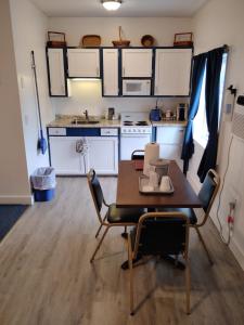 a kitchen with a table and chairs in a room at acadia sunrise motel in Trenton