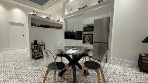 a kitchen with a table and chairs and a refrigerator at Alojamiento Lope d vega in Alba de Tormes +10 photos
