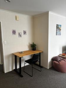 a desk in an office with a plant on a wall at Sunsets over Unsworth in Auckland