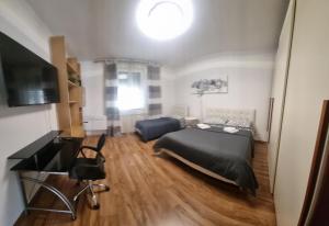 a bedroom with a bed and a flat screen tv at Appartamento Valentinis 74 in Monfalcone