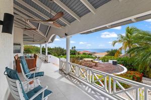 a balcony with chairs and a view of the ocean at Villa Strelitzia in Dorp Soto +33 photos
