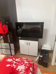 a living room with a flat screen tv on a white cabinet at Kay Borsa in Alba Iulia