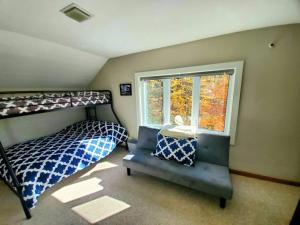 a bedroom with a bed and a window at Fiddlehead Greens in Warren