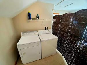 a small laundry room with a washer and dryer at Fiddlehead Greens in Warren +30 photos