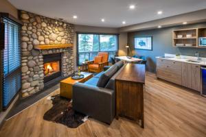 a living room with a couch and a fireplace at Buffalo Mountain Lodge in Banff