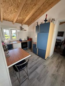 a kitchen with a table and a blue refrigerator at Casa da Roda in Arronches