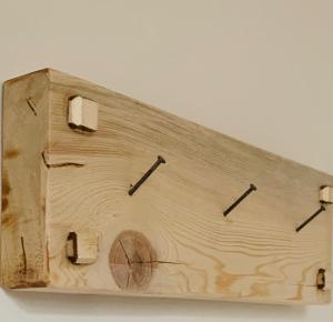 a wooden clock sitting on top of a wall at B&B Morbegno in Morbegno