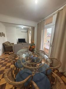 a living room with a glass table and chairs at Apto Pet Friendly com Ar condicionado no Centro in Bagé +16 photos