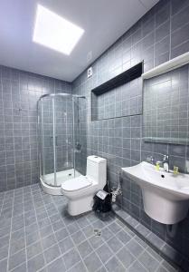 a bathroom with a toilet and a sink and a shower at Hotel All Time in Tbilisi City +54 photos