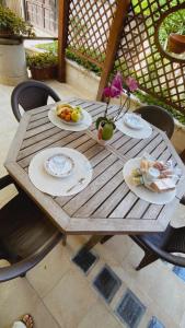 a wooden table with plates of food on it at B&B Le Camelie in Nettuno +32 photos