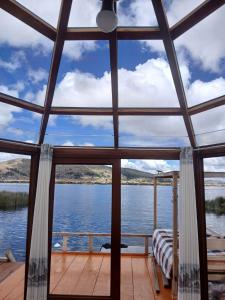 a view from the front porch of a house overlooking the water at Wiñay UTA lodge in Puno