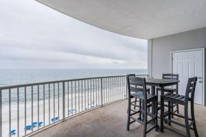 a balcony with a table and chairs and the ocean at Island Royale 1004 by Youngs Suncoast in Gulf Shores