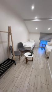 a living room with a couch and a table at Ventė Stay apartment in Ventė
