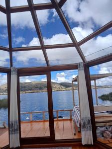 a room with a view of the water at Wiñay UTA lodge in Puno