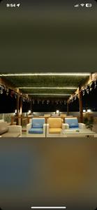 a room with a bunch of chairs and tables at Khufu pyramids boutique hotel in ‘Ezbet `Abd el-Ḥamîd