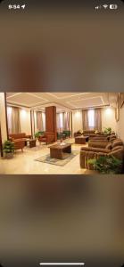 a large living room with couches and a table at Khufu pyramids boutique hotel in ‘Ezbet `Abd el-Ḥamîd +3 photos