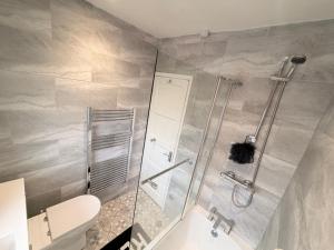 a bathroom with a shower and a toilet at Precious House 4 in Leicester
